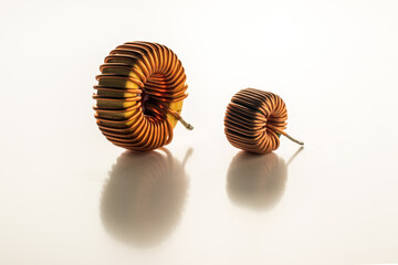 Two electric copper inductor coils of different sizes