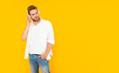 young guy in headphones. music lover. listen to music. wireless device accessory.