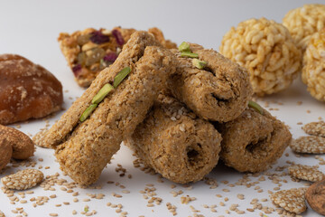 Indian traditional sweets for Makar Sankranti Or Lohri Mithai Gajak Also Known As Gur Gajjak, Gazak, Gachak Til Patti Or Papdi, Chikki Is Made Of Jaggery Gud, Almonds Badam And Pistachio