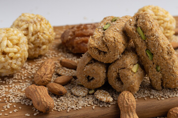 Winter delicacy Indian sweet or mithai with kites for Makar Sankranti Lohri Gajak Also Known As Til Patti Papdi Chikki Gur Gajjak Gazak GachakMade Of Jaggery Gud Almonds Badam And Pistachio