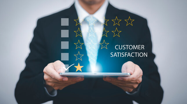 Business hold tablet and Customer review satisfaction feedback survey concept, User give rating to service experience on online application, service leading to reputation ranking of business.