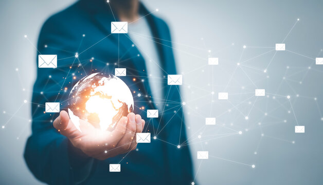 E-mail letter and marketing concept, Businessman hold virtual world and Email pressing for sending the e-mail from the laptop computer, Concept of sending emails,Technology and online communication