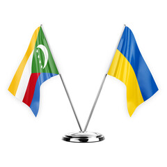 Two table flags isolated on white background 3d illustration, comoros and ukraine