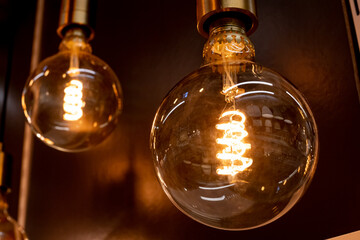 retro lighting.vintage glowing light bulbs on black background.Decorative antique edison style...