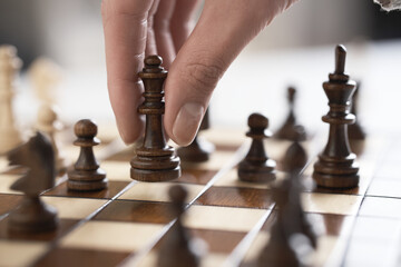 Chess piece Lady. Female hand player girl holds a lady chess piece in the air. Wooden chess piece. Chess board party

