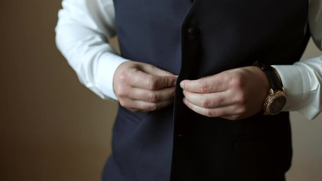 Young businessman gets dressed. Dressing suit.