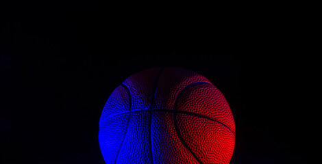 Fototapeta premium Basketball ball isolated on dark background. Blue neon banner. Horizontal sport theme poster, greeting cards, headers, website and app