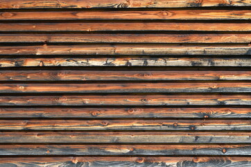 Background. Dark wooden planks are arranged horizontally. Vintage. Surface.
House wall decoration.