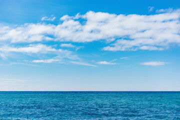 Naklejka na ściany i meble Day view of the sea horizon at summer time.