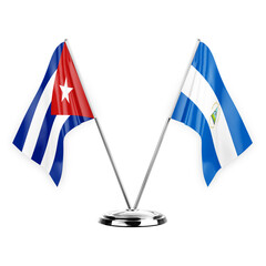 Two table flags isolated on white background 3d illustration, cuba and nicaragua