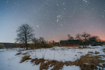 Abandoned village with star trails sky at winter night