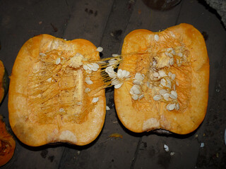 halves of yellow pumpkin with seeds