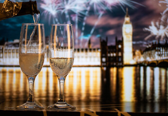 champagne glasses and Big Ben in background New Year's eve in London