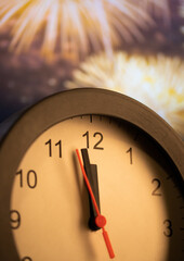 Fototapeta na wymiar clock at midnight and fireworks New Year's eve celebration