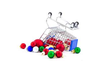 Upside down shopping cart with scattered colorful christmas baubles isolated on white background. Holiday sale. Free up space for new purchases. Concept of compulsive buying disorder or oniomania