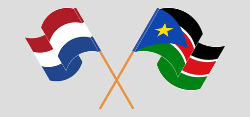 Crossed and waving flags of the Netherlands and South Sudan