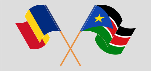Crossed and waving flags of Romania and South Sudan