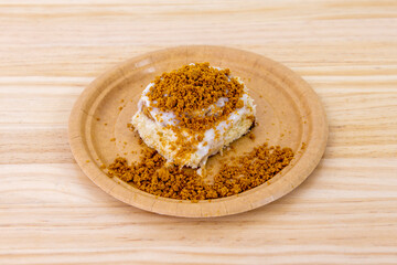 Delicious cinnamon roll with sugar coating and white chocolate with cookie ground on top