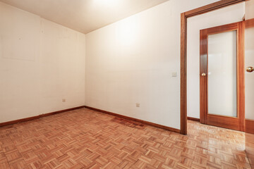 Empty room with cream paint on the walls and mahogany wood carpentry
