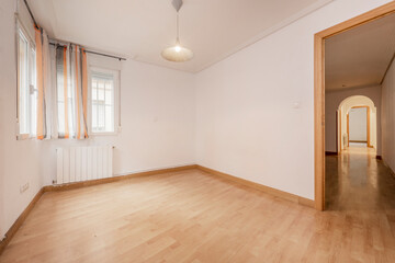 Fototapeta premium Empty room with window with curtains, wooden floors and exit to a larger room with arches in the doors
