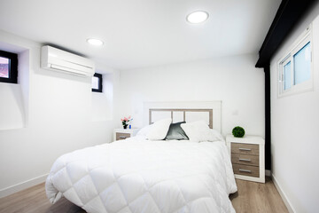 Double bed in vacation rental apartment with contemporary decor and feather bed