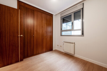 Living room with built-in wardrobe with large mahogany wood doors