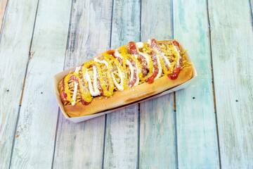 The hot dog is a combination of boiled or fried Viennese sausage, served on a long bun that is often accompanied by a topping, such as ketchup, mustard, jalapeño, onion, and sauerkraut.