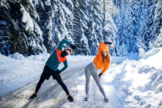 Fitness Couple Doing Exercise At Winter Day