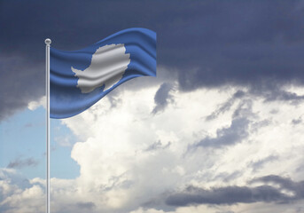 Flag of the Antarctica on a stick, dark clouds in the background