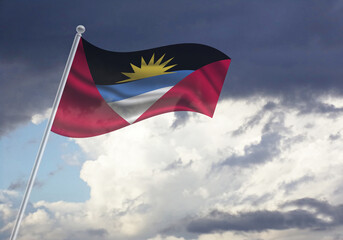 Flag of the Antigua and Barbuda on a stick, dark clouds in the background