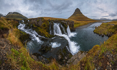 Obraz na płótnie Canvas Famous picturesque Kirkjufell mountain and Kirkjufellsfoss waterfall next to Grundarfjörður at West Iceland autumn view.