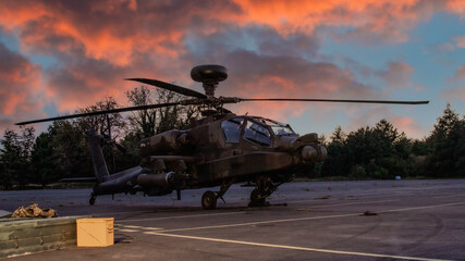 Apache tank buster attack helicopter on the ground at sunset