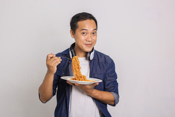 Asian man eats instant noodle with full of smile