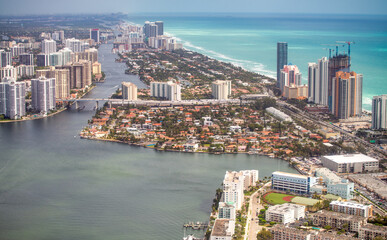 Obraz na płótnie Canvas Aerial view of Miami Beach buildings and canals on a cloudy day, Florida.
