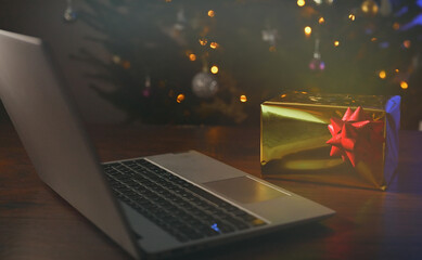 Laptop with christmas tree and gift.