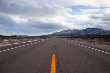 Watching the sunset along the highway. The mountains filled with snow can be seen in the distance. 