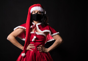 Fototapeta premium Woman Christmas dress. Stay home. Mask face woman. 