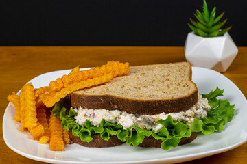 chicken salad sandwich with a side of butternut fries