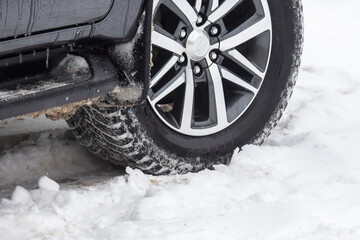 passenger car drives on a snowy road