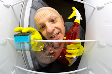cleaning and washing the inside of the refrigerator with a detergent spray and sponge. professional...