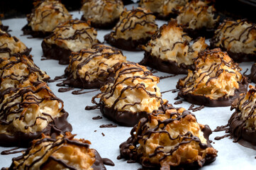 Chocolate drizzled coconut macaroons , selective focus. Homemade cookies with coconut 