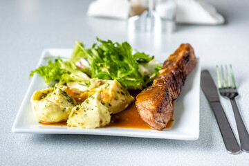 Beef steak with mashed potatoes and rocket salad