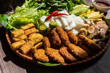 Vietnamese food set, bun dau mam tom, popular street food made from vermicelli with boiled pork, fried tofu, shrimp paste and green vegetables and lemon