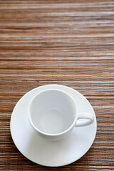 Empty white coffee cup on wooden table