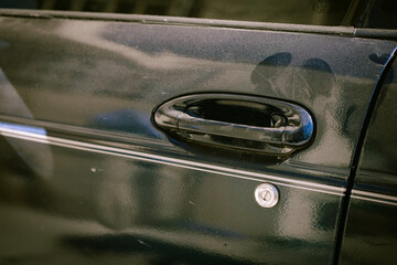 black car door handle with powder