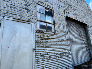 Old creepy scary abandoned building door window and roll door