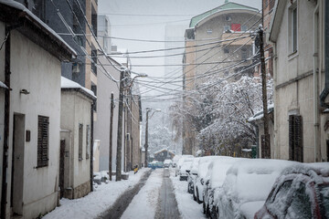 Selective blur on a Typical street of belgrade city center, stari grad, during a snowstorm, with...