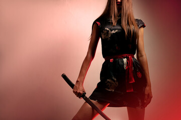 Mysterious , unrecognizable samurai girl, with katana and red light glowing, studio shot