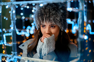 Pretty young woman with fur hat and in elegant coat , with nose piercing , winter portrait 