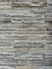 Naklejka premium The background of the arrangement of natural stone in gray color.
